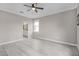 Bedroom features wood-look floors and view into ensuite bathroom at 17541 Corkwood Bend Trl, Punta Gorda, FL 33982