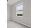 Bedroom with light wood flooring and natural light shining through the window at 17541 Corkwood Bend Trl, Punta Gorda, FL 33982