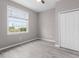 Cozy bedroom features a large window, ceiling fan, and spacious closet at 17541 Corkwood Bend Trl, Punta Gorda, FL 33982