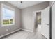 Bright bedroom with hardwood floors, a window with view, and an open door at 17541 Corkwood Bend Trl, Punta Gorda, FL 33982