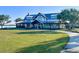 Stunning lakeside clubhouse with a metal roof and beautiful lawn for community events and enjoyment at 17541 Corkwood Bend Trl, Punta Gorda, FL 33982
