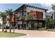 Modern building with sleek architectural design, palm trees, and well-maintained landscaping at 17541 Corkwood Bend Trl, Punta Gorda, FL 33982