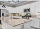 Modern kitchen with stainless steel appliances, granite countertops, and a center island with sink at 17541 Corkwood Bend Trl, Punta Gorda, FL 33982