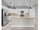 Modern kitchen featuring a spacious island, stainless steel appliances, and ample white cabinetry at 17541 Corkwood Bend Trl, Punta Gorda, FL 33982