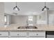 Open floor plan features a large kitchen island with stainless steel sink at 17541 Corkwood Bend Trl, Punta Gorda, FL 33982