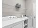 Laundry room with white appliances and wire shelving providing convenient storage at 17541 Corkwood Bend Trl, Punta Gorda, FL 33982