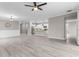 Spacious living area featuring wainscoting details with a clear view into the modern kitchen and stainless appliances at 17541 Corkwood Bend Trl, Punta Gorda, FL 33982
