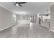 Open-concept living room with light wood floors seamlessly connecting to the adjacent kitchen at 17541 Corkwood Bend Trl, Punta Gorda, FL 33982