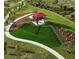 Aerial view of a fun playground with slides, covered seating, and green space for to enjoy at 17541 Corkwood Bend Trl, Punta Gorda, FL 33982
