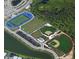 Aerial view of a football field, baseball fields, and recreational amenities in this active community at 17541 Corkwood Bend Trl, Punta Gorda, FL 33982
