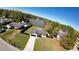 Aerial view of a home with a fenced yard near a tranquil lake and lush greenery at 18614 San Rio Cir, Lutz, FL 33549