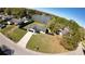 Aerial view of home with spacious yard and a black fence, situated near a serene lake at 18614 San Rio Cir, Lutz, FL 33549