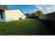 Spacious backyard featuring lush greenery and a dark privacy fence at 18614 San Rio Cir, Lutz, FL 33549