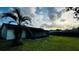 Lush green backyard with a black fence surrounding, providing an opportunity for outdoor activities at 18614 San Rio Cir, Lutz, FL 33549
