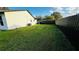 Spacious backyard featuring lush greenery and a dark privacy fence at 18614 San Rio Cir, Lutz, FL 33549