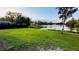 Lush backyard features serene water views and black fence, perfect for enjoying nature at 18614 San Rio Cir, Lutz, FL 33549