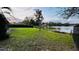 Expansive backyard offers tranquil water views and black fence, providing a peaceful retreat at 18614 San Rio Cir, Lutz, FL 33549