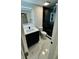 Modern bathroom with sleek vanity, stylish lighting, and a luxurious black marble glass-door shower at 18614 San Rio Cir, Lutz, FL 33549