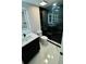 Modern bathroom with sleek vanity, stylish lighting, and a luxurious black marble glass-door shower at 18614 San Rio Cir, Lutz, FL 33549