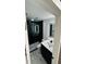Modern bathroom featuring sleek black accents, a glass-enclosed shower, and a stylish, illuminated mirror at 18614 San Rio Cir, Lutz, FL 33549