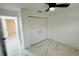 Bright bedroom featuring marble floors, a closet with sleek doors, and a modern ceiling fan at 18614 San Rio Cir, Lutz, FL 33549