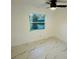 Cozy bedroom featuring a window, white walls and marble floors at 18614 San Rio Cir, Lutz, FL 33549