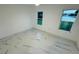 Bright bedroom with marble floors and two windows offering peaceful lake views at 18614 San Rio Cir, Lutz, FL 33549