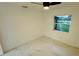 Bright bedroom with marble floors, ceiling fan, and a window view of the serene lake at 18614 San Rio Cir, Lutz, FL 33549