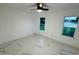Bright bedroom with marble floors, ceiling fan, and a window view of the serene lake at 18614 San Rio Cir, Lutz, FL 33549