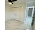 Bright bedroom featuring marble floors, a closet with sleek doors, and a modern ceiling fan at 18614 San Rio Cir, Lutz, FL 33549