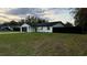 Charming single-story home featuring a well-maintained lawn, dark fenced in yard and an attached two-car garage at 18614 San Rio Cir, Lutz, FL 33549