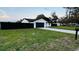 Attractive single-story home boasting a lush green lawn and a practical two-car garage at 18614 San Rio Cir, Lutz, FL 33549
