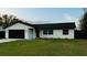 Inviting single-story home with a well-manicured lawn and a convenient two-car garage at 18614 San Rio Cir, Lutz, FL 33549
