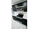 Kitchen with stainless steel appliances, white countertops, black cabinets and modern backsplash at 18614 San Rio Cir, Lutz, FL 33549