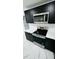 Kitchen with stainless steel appliances, white countertops, black cabinets and modern backsplash at 18614 San Rio Cir, Lutz, FL 33549