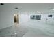 Open-concept living room with marble floors, a window and direct access to a bright, modern bathroom at 18614 San Rio Cir, Lutz, FL 33549