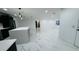 Spacious living room with sleek marble floors, recessed lighting, and an open layout at 18614 San Rio Cir, Lutz, FL 33549