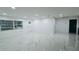 Bright living room with white walls, and glossy marble floors reflecting light from window at 18614 San Rio Cir, Lutz, FL 33549
