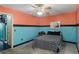 Comfortable bedroom with a ceiling fan and a queen bed with unique comforter and a neutral color scheme at 2100 World Parkway Blvd # 30, Clearwater, FL 33763