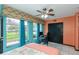Well-lit bedroom featuring large windows, desk area, closet, and a cozy bed at 2100 World Parkway Blvd # 30, Clearwater, FL 33763