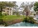 Well-maintained apartment complex with landscaping, trees, and green space at 2100 World Parkway Blvd # 30, Clearwater, FL 33763
