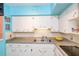 Kitchen features white cabinets, ample countertop space, and modern appliances, with an undermount sink at 2100 World Parkway Blvd # 30, Clearwater, FL 33763