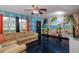 Comfortable living room with a large sofa, unique wall mural, and a tropical view outside at 2100 World Parkway Blvd # 30, Clearwater, FL 33763
