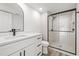 Modern bathroom features sleek vanity, black hardware, and glass-enclosed shower at 2101 Cordova Grn, Seminole, FL 33777