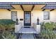 Inviting front entrance with decorative lanterns and well-maintained landscaping at 2101 Cordova Grn, Seminole, FL 33777