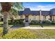 Charming townhouse featuring a unique roofline, well-maintained landscaping, and a welcoming entrance at 2101 Cordova Grn, Seminole, FL 33777