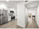 Well-equipped kitchen with stainless appliances, white cabinets, and sight lines to the living room at 2101 Cordova Grn, Seminole, FL 33777