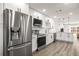 Modern kitchen featuring stainless steel appliances, white cabinets, and sleek countertops at 2101 Cordova Grn, Seminole, FL 33777