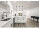 Bright kitchen with white cabinets, stainless steel appliances, and pendant lighting at 2101 Cordova Grn, Seminole, FL 33777