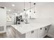 Updated kitchen with quartz countertops, stainless appliances, and modern pendant lighting at 2101 Cordova Grn, Seminole, FL 33777